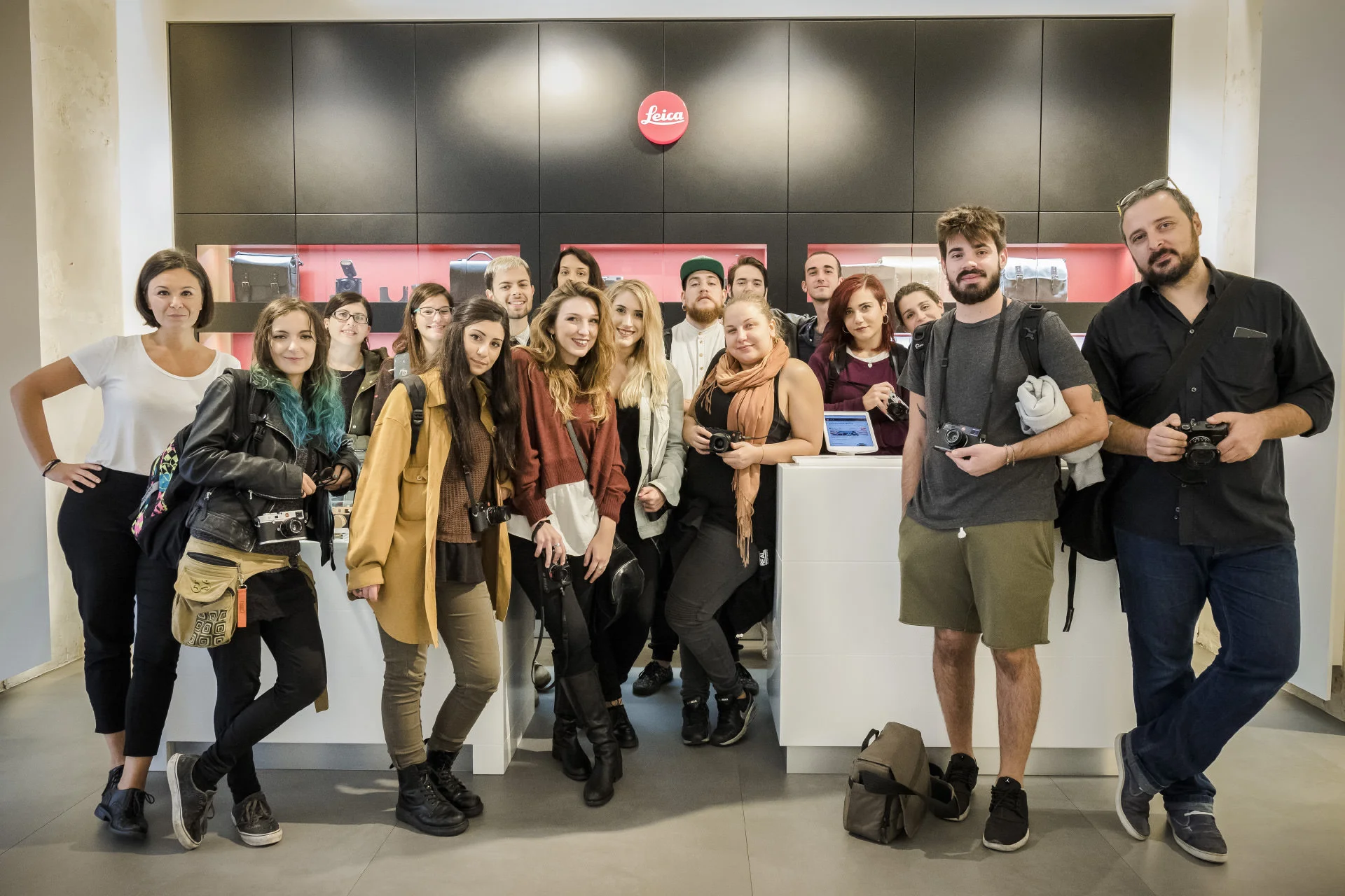 Students and their instructor pose together in an exhibition space