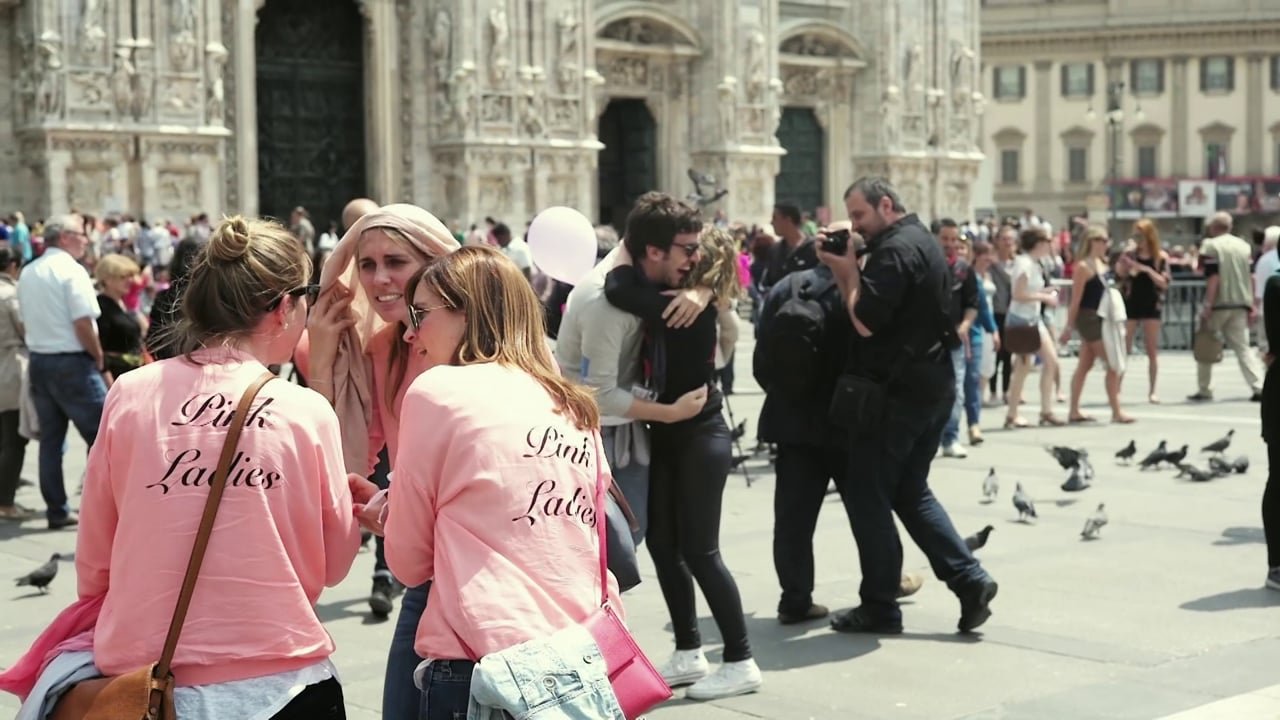 People gather in a sunny square during a photography workshop