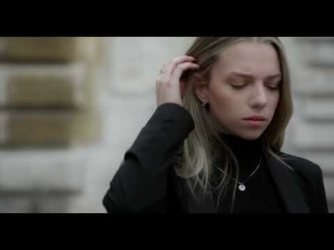 A woman adjusts her hair in a Leica photography film thumbnail