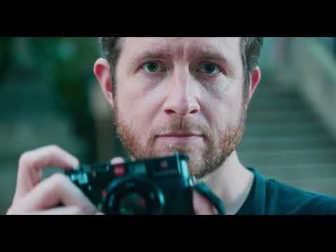John Sypal holds a camera in a documentary thumbnail